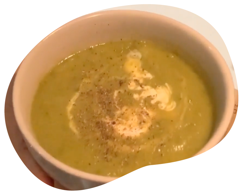 White bowel, green soup with cream and pepper.